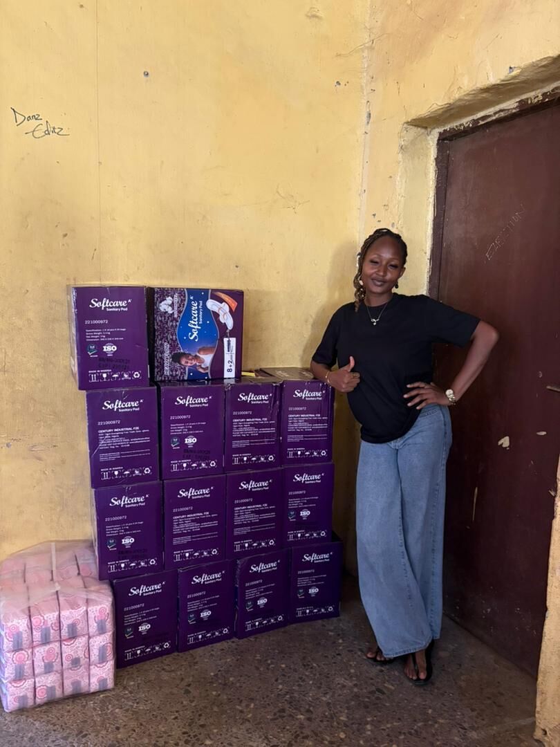 Maryjane Ejebughaobi with donated menstrual care supplies
