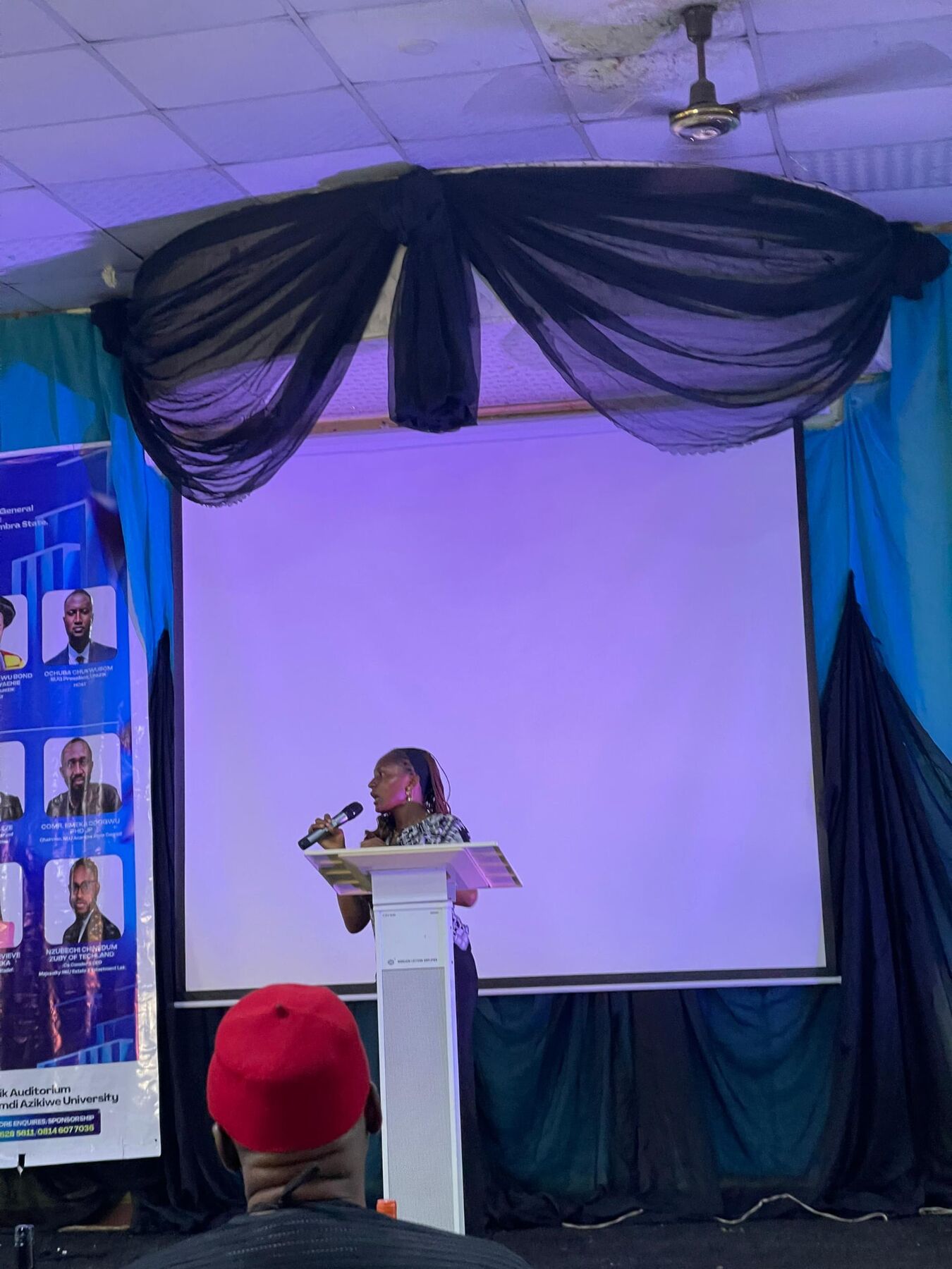 Maryjane Ejebughaobi speaking at a lectern during a university event