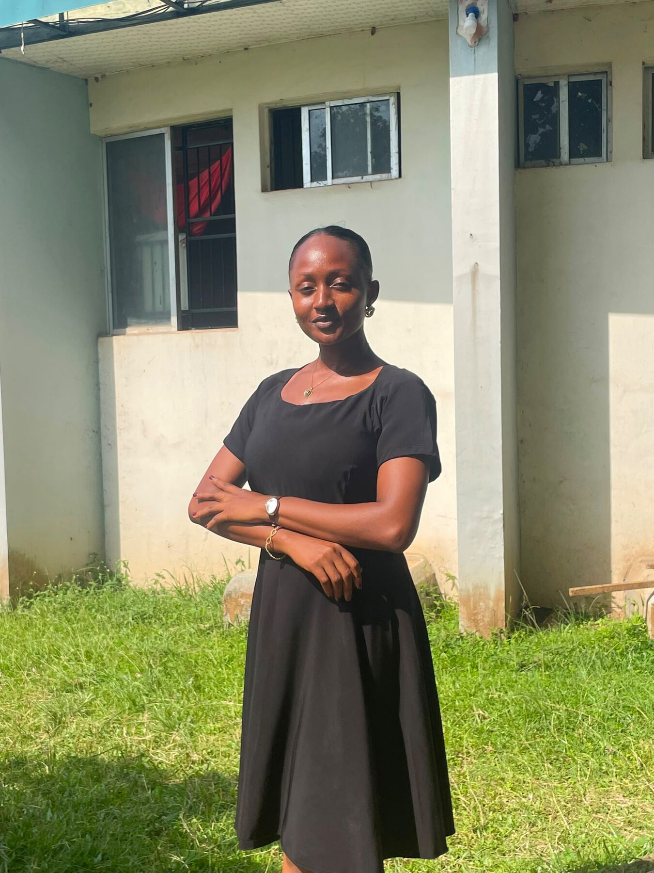 Maryjane Ejebughaobi posing outdoors in a black dress