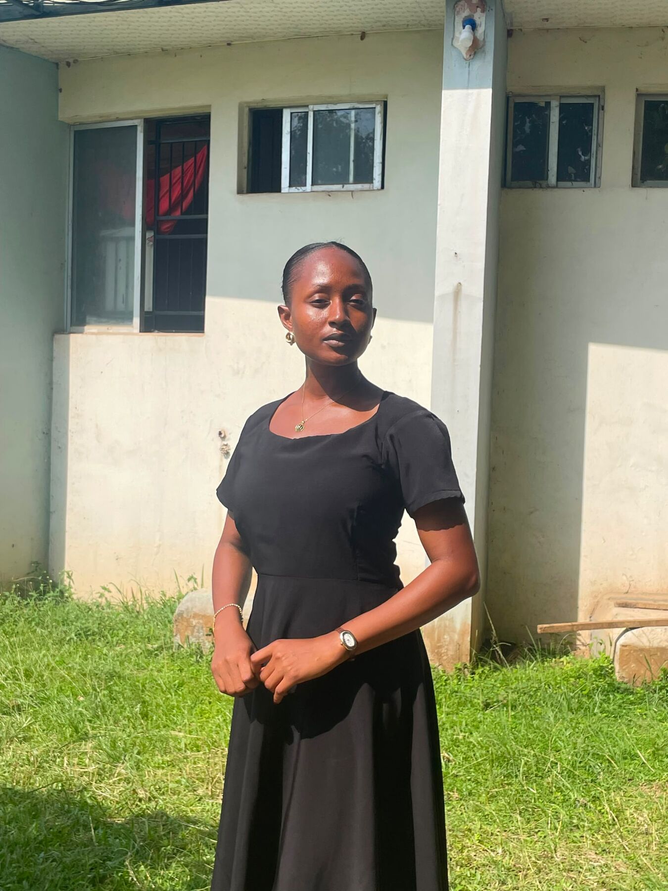 Maryjane Ejebughaobi standing outdoors in a black dress